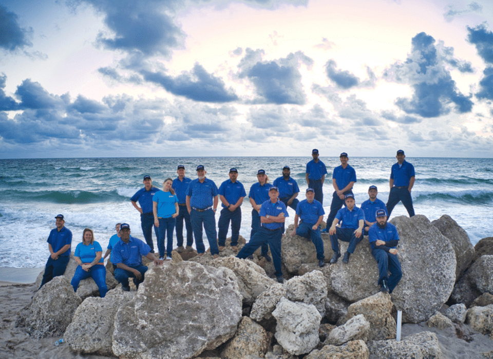john-the-plumber-team-at-beach-on-rocks1