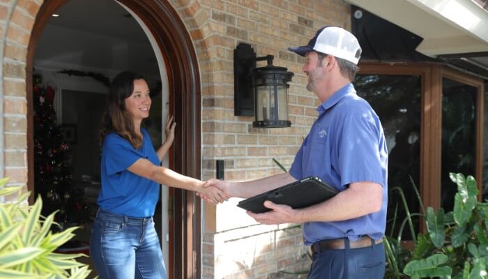 john the plumber technician greeting customer