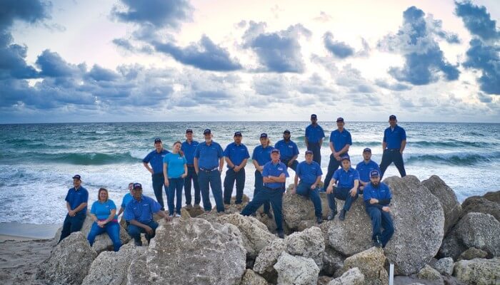 jphn the plumber team at beach on rocks jphn the plumber team at beach on rocks
